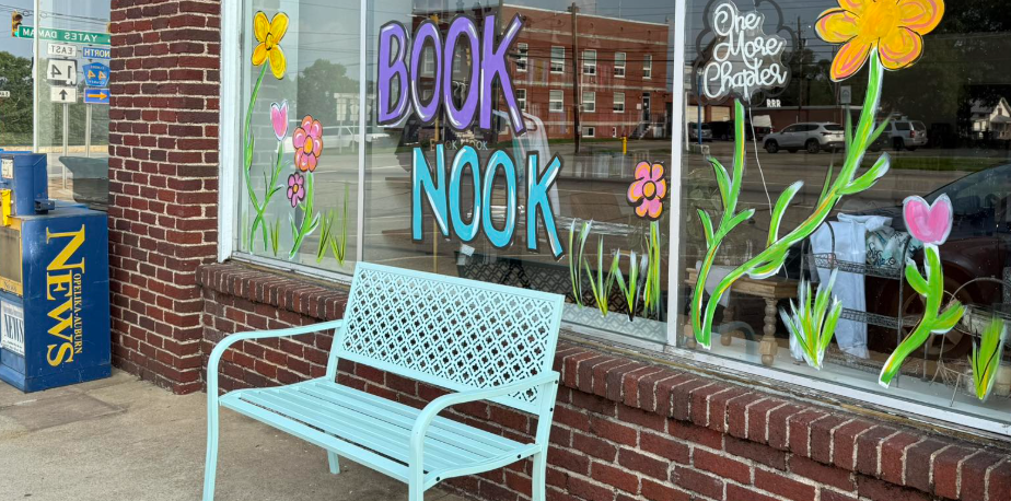 a bench and painted window depicting the new book nook location